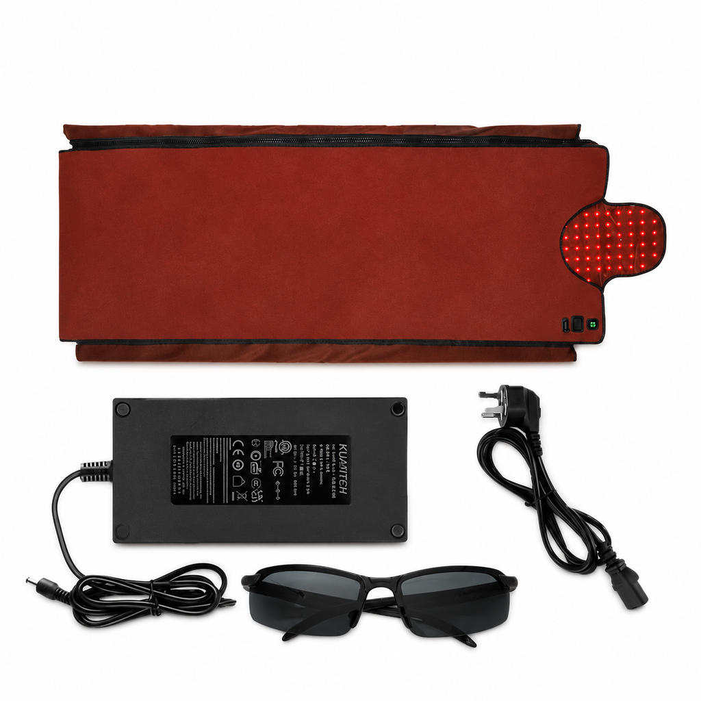 An electric heating pad set shown on a white background, including a red heated pad, a black power adapter with cord, black protective glasses, and a red LED light panel.